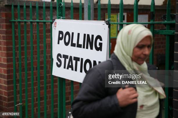 Muslim woman walks past a polling station set up at the Muslim community centre in Ilford, east London, on June 8 as Britain holds a general...