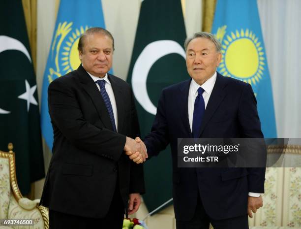 Kazakh President Nursultan Nazarbayev shakes hands with Pakistani Prime Minister Nawaz Sharif during their meeting in Astana on June 8, 2017.