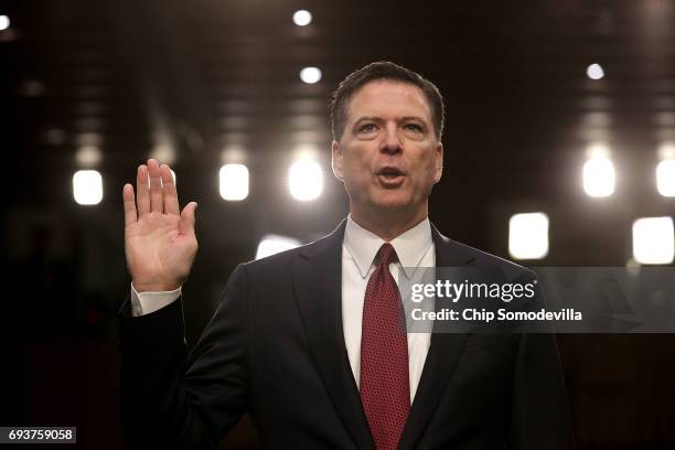 Former FBI Director James Comey is sworn in while testifying before the Senate Intelligence Committee in the Hart Senate Office Building on Capitol...