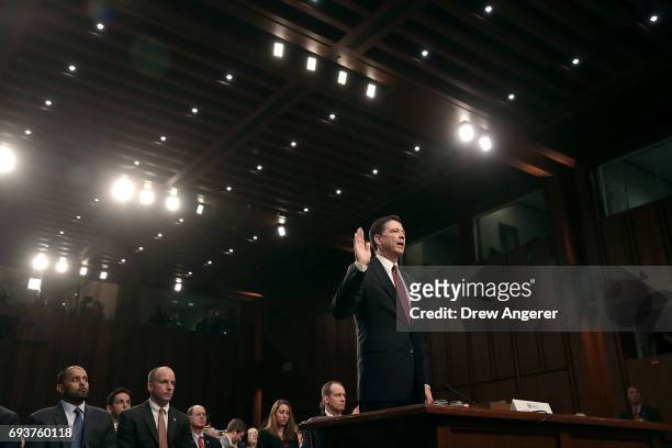 Former FBI Director James Comey is sworn-in before testifying before the Senate Intelligence Committee in the Hart Senate Office Building on Capitol...
