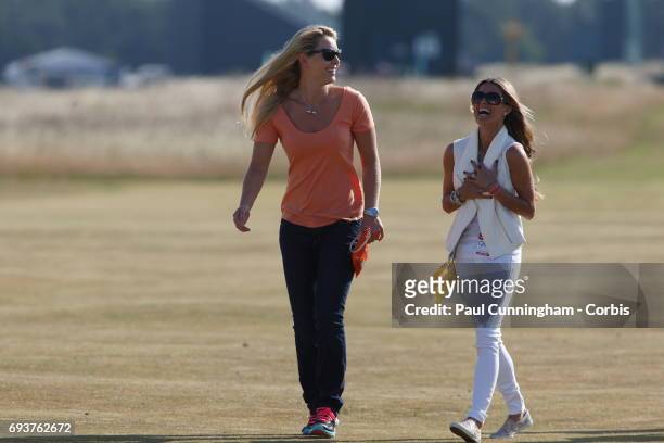 Lindsey Vonn with Fred Couples girlfriend Nadine Moze laugh out loud on the16th fairway during the first round of The Open Championship 2013 at...
