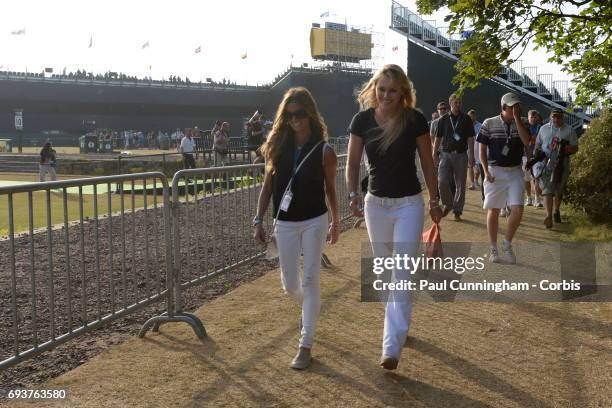 Lindsey Vonn with Nadine Moze at the 18th green and Club House at the end of Tiger Woods round during the third round of The Open Championship 2013...