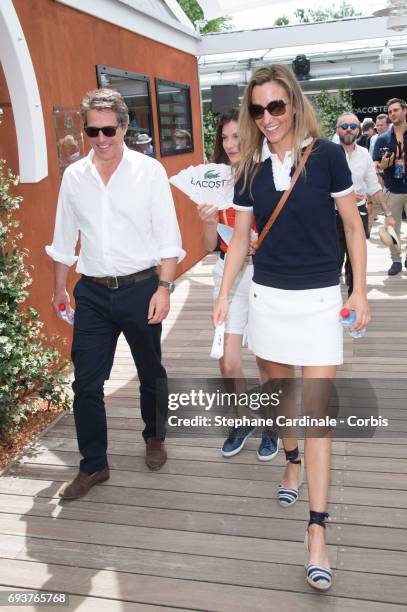Hugh Grant and his companion Anna Eberstein attend the French Tennis Open 2017 - Day Twelve at Roland Garros on June 8, 2017 in Paris, France.