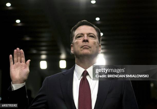 Former FBI director James Comey is sworn in during a hearing before the Senate Select Committee on Intelligence on Capitol Hill June 8, 2017 in...