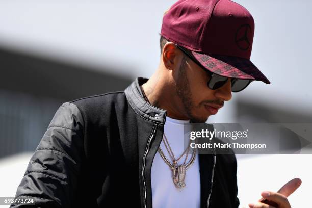 Lewis Hamilton of Great Britain and Mercedes GP walks in the Paddock during previews for the Canadian Formula One Grand Prix at Circuit Gilles...