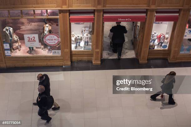 Shoppers pass in front of a Mimo & Co. Store inside the Alto Palermo shopping mall in Buenos Aires, Argentina, on Friday, May 12, 2017. Buenos Aires...
