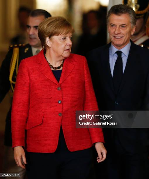 German Chancellor Angela Merkel and President of Argentina Mauricio Macri walk into the Casa Rosada prior a press conference as part of an official...