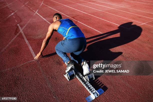 Local sprinter trains in an outfield track at the national stadium in Kingston, Jamaica, on June 8, 2017. Usain Bolt's imminent retirement is a blow...