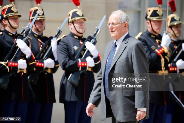 Peruvian President Pedro Pablo Kuczynski walks past Republican Guards as he arrives before his meeting with French President Emmanuel Macron at the...