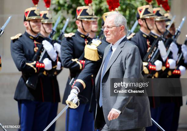 Peruvian President Pedro Pablo Kuczynski walks past Republican Guards as he arrives before his meeting with French President Emmanuel Macron at the...