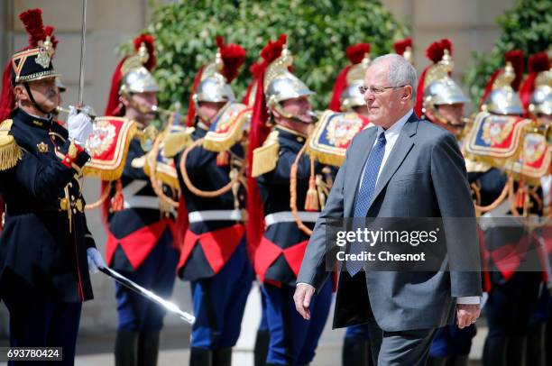 Peruvian President Pedro Pablo Kuczynski walks past Republican Guards as he arrives before his meeting with French President Emmanuel Macron at the...