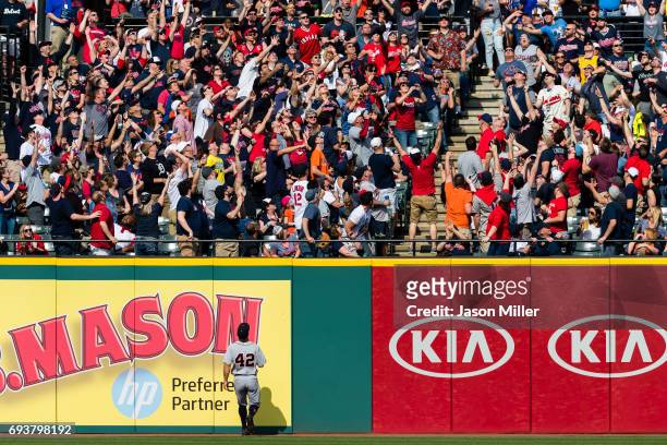 Right fielder Tyler Collins of the Detroit Tigers watches along with fans for a home run hit by Jose Ramirez of the Cleveland Indians during the...