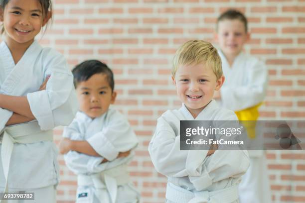 kids at martial arts practice - kids martial arts stock pictures, royalty-free photos & images