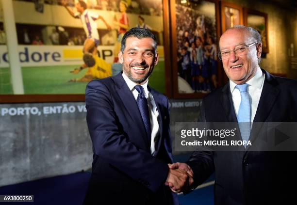Porto's new coach Sergio Conceicao shakes hands with Porto's President Jorge Nuno Pinto da Costa during his official presentation at the Dragao...