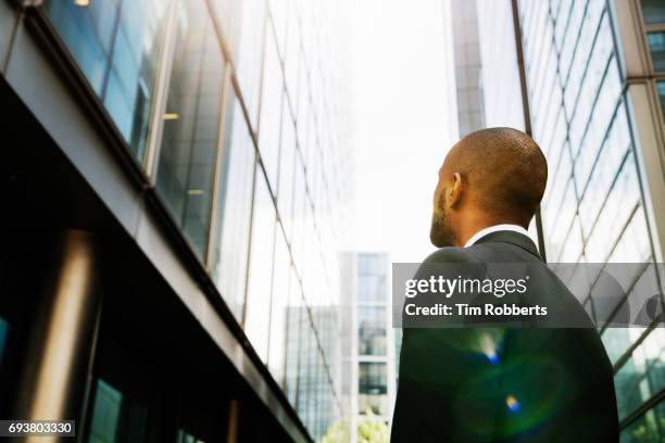 business man looking up - looking up at buildings stock pictures, royalty-free photos & images