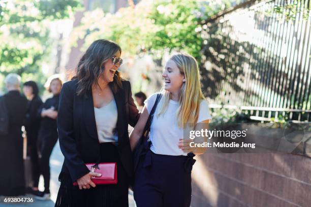 Mariska Hargitay wears a black and white outfit and carries a red YSL clutch outside the Stella McCartney Spring 18 presentation on June 8, 2017 in...