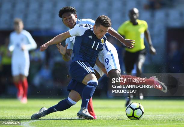 Scotland's Adam Frizzell vies with England's Demetri Mitchell during the Under 21 international football semi- final match Scotland vs England at the...