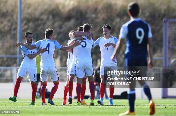 England's players Elliott Embleton, Joshua Tymon, Joseph Worrall and George Hirst celebrate after England's midfielder Harvey Barnes scored a goal...