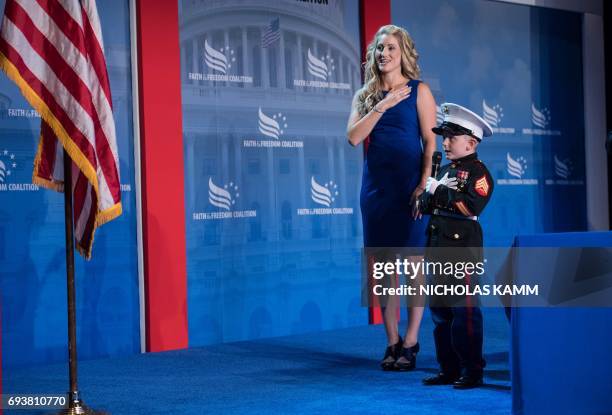 Six-year-old Christian Jacobs says the Pledge of Allegiance with his mother Brittany Jacobs before US President Donald Trump addresses the Faith and...