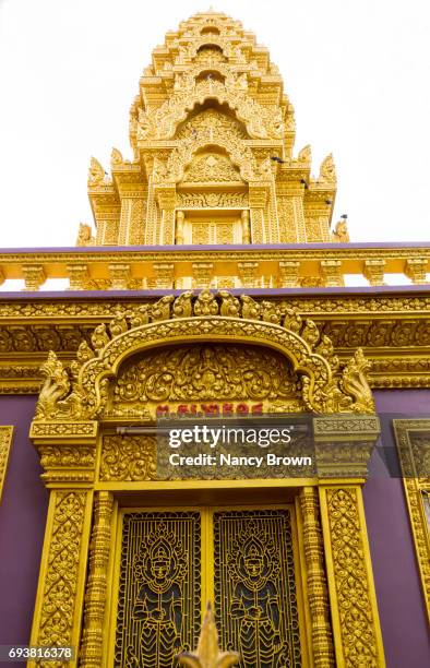 decorative doorway and pagoda in wat qunalom in phnom penh in cambodia. - wat ounalom stock pictures, royalty-free photos & images