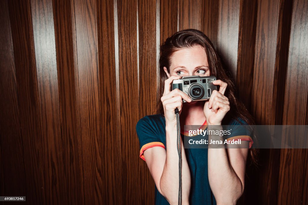 Woman Hiding Face Behind Camera