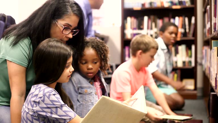 https://media.gettyimages.com/id/693824198/video/education-brarian-reads-book-to-elementary-students-in-library-or-classroom.jpg?b=1&s=640x640&k=20&c=6zszI1YbETw9-bDDmI64c2l_7szYQEsrzPI1C9AADrA=