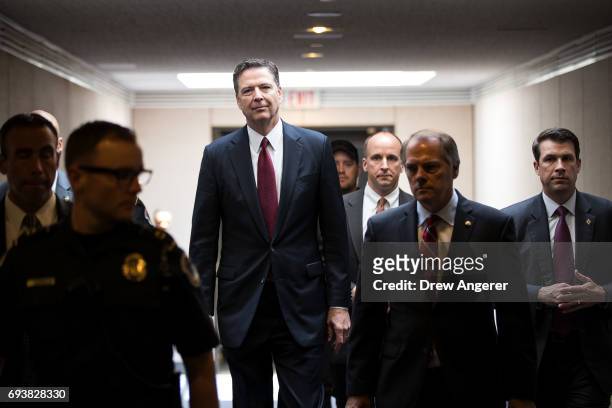 Former FBI Director James Comey leaves a closed session with the Senate Intelligence Committee in the Hart Senate Office Building on Capitol Hill...