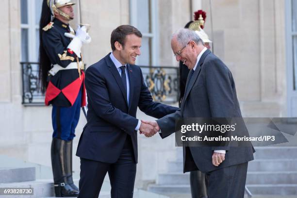 French President Emmanuel Macron welcomes President of the Republic of Peru Pedro Pablo Kuczynski for a meeting at the Elysee Palace on June 8, 2017...