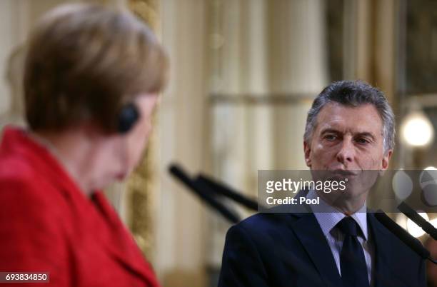 President of Argentina Mauricio Macri speaks to German Chancellor Angela Merkel during a press conference as part of an official visit of German...