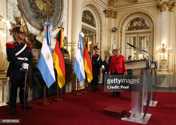 German Chancellor Angela Merkel and President of Argentian Mauricio Macri walk towards their stands for a press conference as part of an official...
