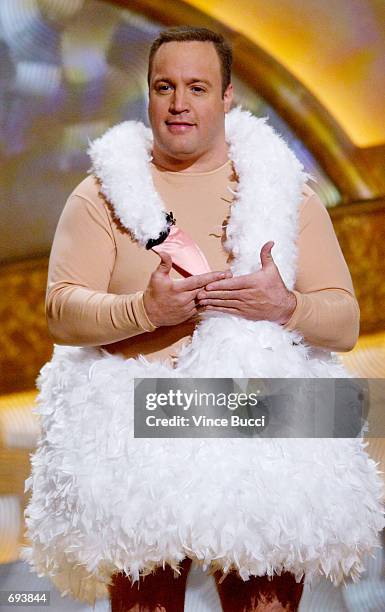 Actor and host Kevin James wears a swan dress on stage during the 28th Annual Peoples Choice Awards at the Pasadena Civic Center January 13, 2002 in...