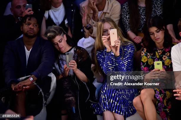 Guest, Singer Peaches, Actress Lilith Stangenberg and Model Marie Nasemann take a photo with their smartphone of designer Vivienne Westwood during a...