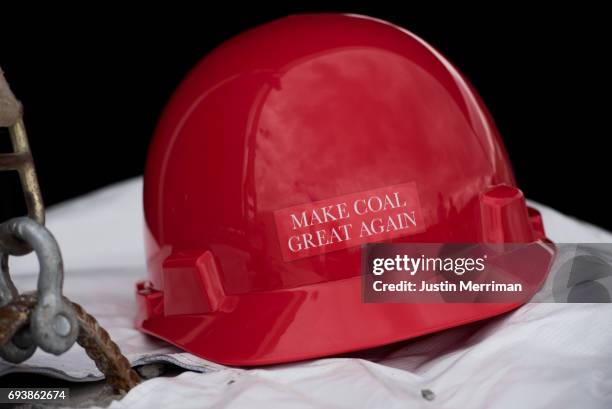 Make Coal Great Again" hard hat sits on a table at the grand opening of Corsa Coal's Acosta Deep Mine on June 8, 2017 in Friedens, Pennsylvania. The...