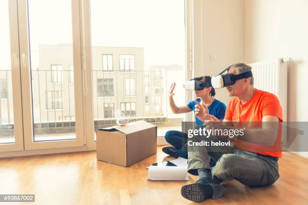 couple with vr headset moving home - cardboard vr stock pictures, royalty-free photos & images