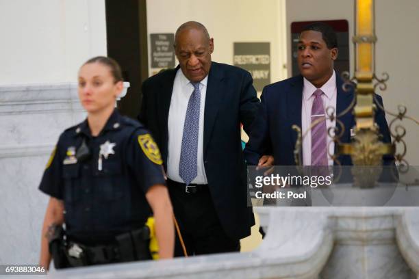 Actor Bill Cosby returns to the courtroom with aide Andrew Wyatt following a break in Cosby's trial on sexual assault charges at the Montgomery...