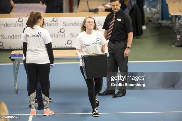 Volunteer handles a ballot box for three constituencies in Tyne and Wear ceremonial county at the Silksworth Community Pool, Tennis and Wellness...