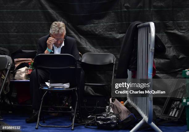 Former Northern Ireland First Minister and DUP leader Peter Robinson crunches numbers for his party as counting gets underway at the Titanic...