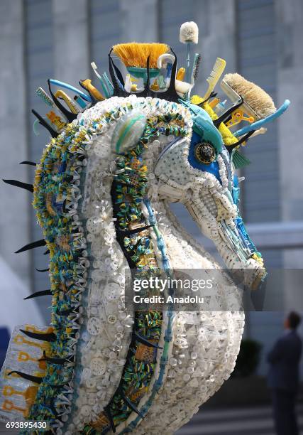 Sea-horse sculpture, made with plastic wastes and trashes those taken out from oceans and seas is being displayed by "Washed Ashore" in front of the...