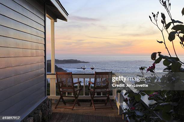 deck, chairs and  wine overlooking sea and sunset - mendocino county stock pictures, royalty-free photos & images