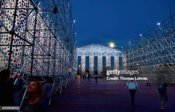 The artwork 'The Parthenon of Books' with donated books by the artist Marta Minujin is illuminated by light and the full moon on June 8, 2017 in...