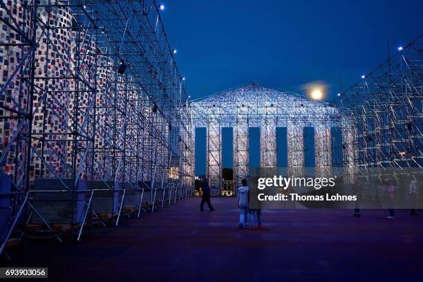 The artwork 'The Parthenon of Books' with donated books by the artist Marta Minujin is illuminated by light and the full moon on June 8, 2017 in...