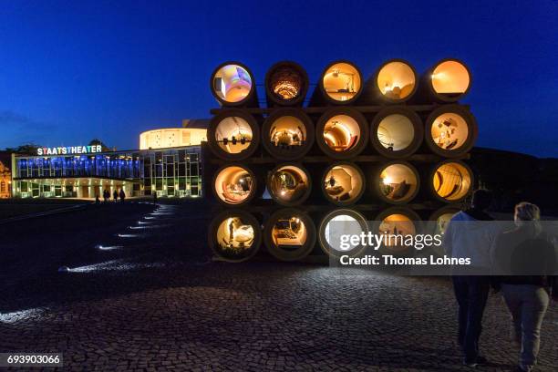 People look at the illumenated installation 'When We Were Exhaling Images' by the artist Hiwa K at night on June 8, 2017 in Kassel, Germany. The...