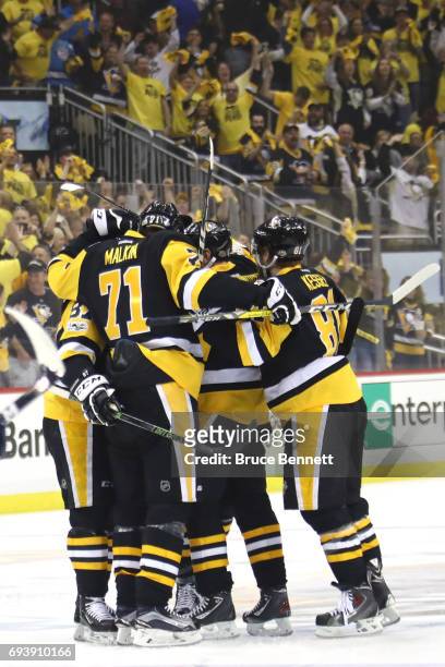 Justin Schultz of the Pittsburgh Penguins celebrates with teammates after scoring a goal in the first period against the Nashville Predators in Game...