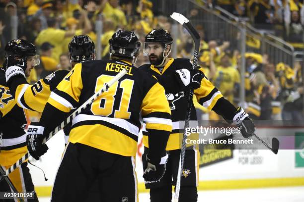 Justin Schultz of the Pittsburgh Penguins celebrates with teammates after scoring a goal in the first period against the Nashville Predators in Game...