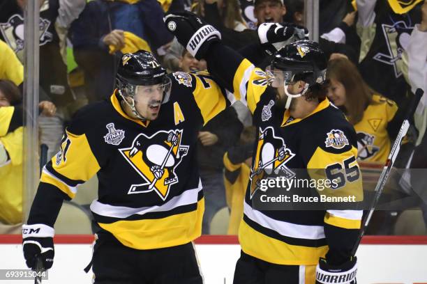 Evgeni Malkin of the Pittsburgh Penguins celebrates with Ron Hainsey after scoring his team's third goal in the first period against the Nashville...