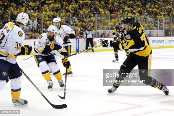 Evgeni Malkin of the Pittsburgh Penguins scores his team's third goal in the first period against Viktor Arvidsson and Yannick Weber of the Nashville...