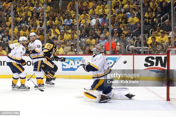Evgeni Malkin of the Pittsburgh Penguins scores is team's third goal of the first period against Yannick Weber, Viktor Arvidsson and goalie Pekka...