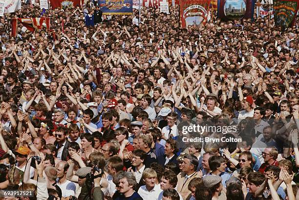 Crowd of miners and their supporters applaud National Union of Mineworkers President Arthur Scargill, as he speaks during a protest rally against pit...