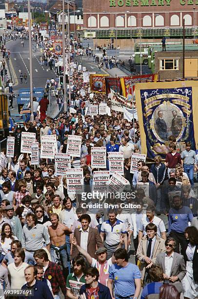 Miners carrying banners and placards, which read 'Victory To The Miners' march through the streets during a protest rally against pit closures in...