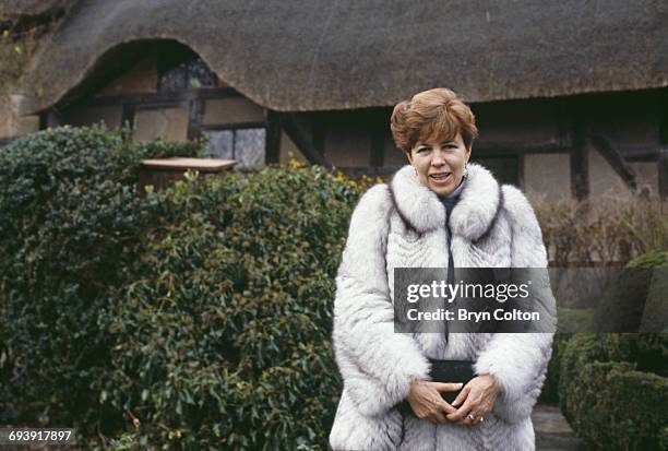 Raisa Gorbachev, wife of Mikhail Gorbachev, Russian Politburo member and second in line at the Kremlin, stands dressed in a fur jacket as she poses...